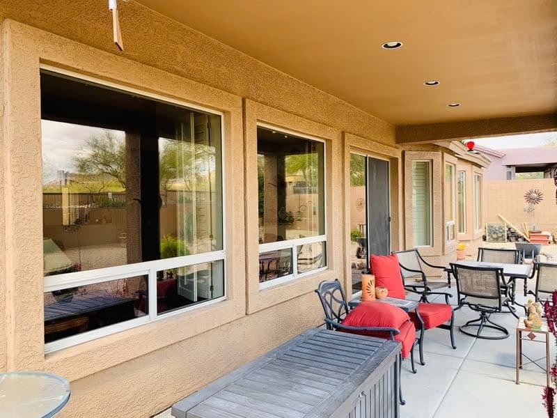 Clean reflective patio windows on a stucco East Valley home after professional washing